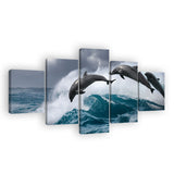 Dolphins Jumping Over Breaking Wave Canvas Wall Art